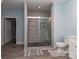 Modern bathroom showcasing a tiled shower and clean fixtures complemented by a light blue wall at 4008 Widgeon Way, Waxhaw, NC 28173
