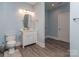 Well-lit bathroom with a toilet, vanity with ample storage and light blue walls at 4008 Widgeon Way, Waxhaw, NC 28173