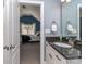 Bathroom with a view into the bedroom, features a vanity with a dark countertop and white cabinets at 4008 Widgeon Way, Waxhaw, NC 28173