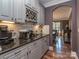 Convenient butler's pantry with sleek countertops, wine storage, and modern appliances at 4008 Widgeon Way, Waxhaw, NC 28173