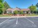 Community clubhouse featuring manicured landscaping, ample parking, and covered outdoor space at 4008 Widgeon Way, Waxhaw, NC 28173