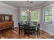 Charming dining area with natural light, a dark wood table, and a classic sideboard at 4008 Widgeon Way, Waxhaw, NC 28173