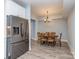 A dining room features modern flooring, ample room with a table for six, and a stainless steel refrigerator in the background at 4008 Widgeon Way, Waxhaw, NC 28173