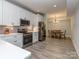 Bright kitchen with stainless steel appliances, white cabinets and a dining area creating an inviting and functional space at 4008 Widgeon Way, Waxhaw, NC 28173