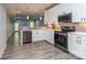 Modern kitchen featuring stainless steel appliances, white cabinets, and sleek countertops, creating a stylish and functional space at 4008 Widgeon Way, Waxhaw, NC 28173
