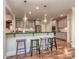 Bright kitchen with gray cabinets, a breakfast bar, and stylish pendant lighting at 4008 Widgeon Way, Waxhaw, NC 28173