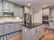 Stylish kitchen boasting granite countertops, stainless appliances, subway tile backsplash, and gray cabinetry at 4008 Widgeon Way, Waxhaw, NC 28173