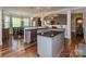An open concept kitchen showcasing stainless steel appliances and granite countertops and hardwood floors at 4008 Widgeon Way, Waxhaw, NC 28173