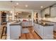 Well-appointed kitchen with modern appliances, gray cabinetry, and a convenient breakfast bar at 4008 Widgeon Way, Waxhaw, NC 28173