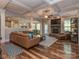 Spacious living room with coffered ceilings, a stone fireplace, and comfortable leather seating at 4008 Widgeon Way, Waxhaw, NC 28173