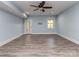 Inviting living room with a ceiling fan, French door and light blue walls complemented by a hardwood floor at 4008 Widgeon Way, Waxhaw, NC 28173