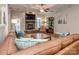 Inviting living room showcasing a stone fireplace, comfortable seating, and a ceiling fan at 4008 Widgeon Way, Waxhaw, NC 28173