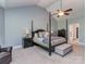 This main bedroom features vaulted ceilings, a ceiling fan, an ensuite bathroom, and a four-poster bed at 4008 Widgeon Way, Waxhaw, NC 28173