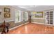 Dining room features hardwood floors, a chandelier, windows with shutters, and unique decor at 422 Wildwood Dr, Salisbury, NC 28146