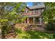 Beautiful brick home featuring a covered front porch, white columns, and classic black shutters at 422 Wildwood Dr, Salisbury, NC 28146