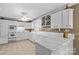 Bright kitchen features white cabinetry, tile countertops, and a wine rack above the sink at 422 Wildwood Dr, Salisbury, NC 28146
