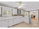 Bright kitchen with tile countertops, white cabinetry, wine rack, and adjoining rooms at 422 Wildwood Dr, Salisbury, NC 28146