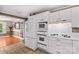 Bright kitchen features white cabinetry and appliances with an entrance to another room at 422 Wildwood Dr, Salisbury, NC 28146