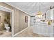Eat-in kitchen featuring white cabinets and appliances, and access to half-bath at 422 Wildwood Dr, Salisbury, NC 28146
