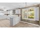 Bright kitchen featuring white cabinets and a large window at 422 Wildwood Dr, Salisbury, NC 28146