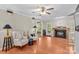 Cozy living room with fireplace, ceiling fan, and armchairs at 422 Wildwood Dr, Salisbury, NC 28146