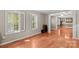 Bright living room featuring wood floors, plantation shutters, and open access to dining room at 422 Wildwood Dr, Salisbury, NC 28146