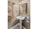 Compact powder room featuring a pedestal sink and decorative mirror at 422 Wildwood Dr, Salisbury, NC 28146