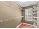 A walk-in closet with wood floors, one window with white shutters, and white wire shelves at 422 Wildwood Dr, Salisbury, NC 28146