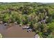 Beautiful aerial of lake homes with private boat docks nestled among mature trees, offering a serene escape at 531 Hattaway Dr, Mount Gilead, NC 27306