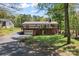 Two-story home featuring a rear garage and large deck, nestled in a serene wooded setting at 531 Hattaway Dr, Mount Gilead, NC 27306