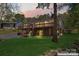 Home exterior with a spacious deck, brick foundation, outdoor stairs and yard at 531 Hattaway Dr, Mount Gilead, NC 27306