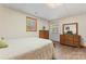 This bedroom features a wood dresser, an exit door, wood flooring, and light colored walls at 531 Hattaway Dr, Mount Gilead, NC 27306
