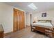This bedroom features a closet, a wood frame bed, a skylight, and light-colored walls at 531 Hattaway Dr, Mount Gilead, NC 27306