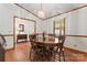 Traditional dining room features wood floors, chandelier, and trim, perfect for entertaining at 531 Hattaway Dr, Mount Gilead, NC 27306