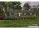 Charming single story home featuring a lovely front porch, well-manicured lawn and tasteful landscaping at twilight at 531 Hattaway Dr, Mount Gilead, NC 27306