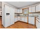 Efficient kitchen featuring white appliances, window, granite countertops, and generous cabinet space at 531 Hattaway Dr, Mount Gilead, NC 27306
