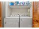 This laundry room features a washer and dryer and wooden closet doors at 531 Hattaway Dr, Mount Gilead, NC 27306