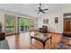 Spacious living room with vaulted ceilings, skylights, hardwood floors, and sliding glass doors to the deck at 531 Hattaway Dr, Mount Gilead, NC 27306
