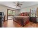 Comfortable bedroom with a ceiling fan and access to a private outdoor deck at 531 Hattaway Dr, Mount Gilead, NC 27306