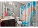 Cozy bathroom with blue patterned shower curtain, stylish sink and cabinet, and a relaxing atmosphere at 5310 Glenlea Walk Ln, Charlotte, NC 28216