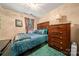 Comfortable bedroom featuring a bed with blue bedding, wooden dresser, and soft green carpet at 5310 Glenlea Walk Ln, Charlotte, NC 28216