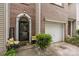Charming brick townhome features a black front door and a one car garage at 5310 Glenlea Walk Ln, Charlotte, NC 28216