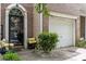 Exterior view of a charming brick townhome with front door and one car garage at 5310 Glenlea Walk Ln, Charlotte, NC 28216