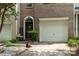 Charming brick townhome features a black front door and a one car garage at 5310 Glenlea Walk Ln, Charlotte, NC 28216