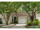Charming townhouse featuring brick accents, a one-car garage, and a welcoming front entrance at 5310 Glenlea Walk Ln, Charlotte, NC 28216