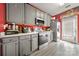 This gray kitchen features modern stainless steel appliances, gray cabinets, and easy access to the back door at 5310 Glenlea Walk Ln, Charlotte, NC 28216