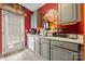 Cozy kitchen has gray cabinets and countertops, stainless steel appliances, and back door access at 5310 Glenlea Walk Ln, Charlotte, NC 28216