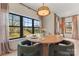Charming dining area with a round table, modern lighting, and large windows with backyard views at 706 Falling Oak Aly # 16, Huntersville, NC 28078