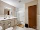 Bright bathroom featuring a shower-tub combo, cabinets, and tiled walls at 7516 Pageland Hwy # 3, Monroe, NC 28112
