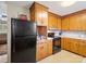 Kitchen featuring wood cabinets and modern appliances including a black refrigerator at 7516 Pageland Hwy # 3, Monroe, NC 28112